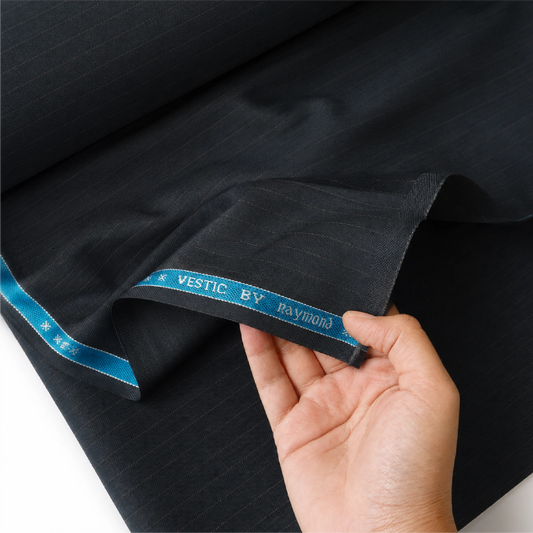 Close-up of Raymond Vestic charcoal pinstripe suiting fabric showing its texture and drape