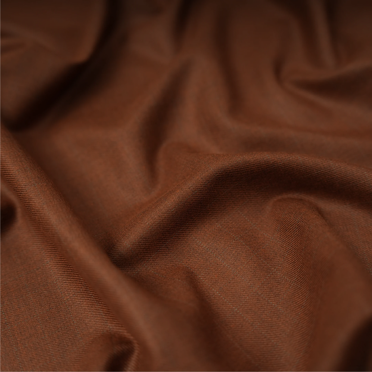 Close-up of Raymond Bellismo rust brown suiting fabric showing its fine texture